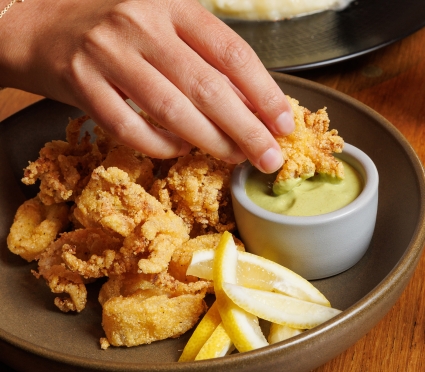 dipping calamari in sauce