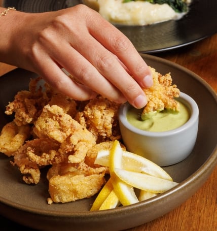 dipping calamari in sauce