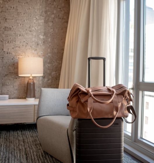 stylish leather bag in a luxurious hotel room at Smyth Tribeca NYC