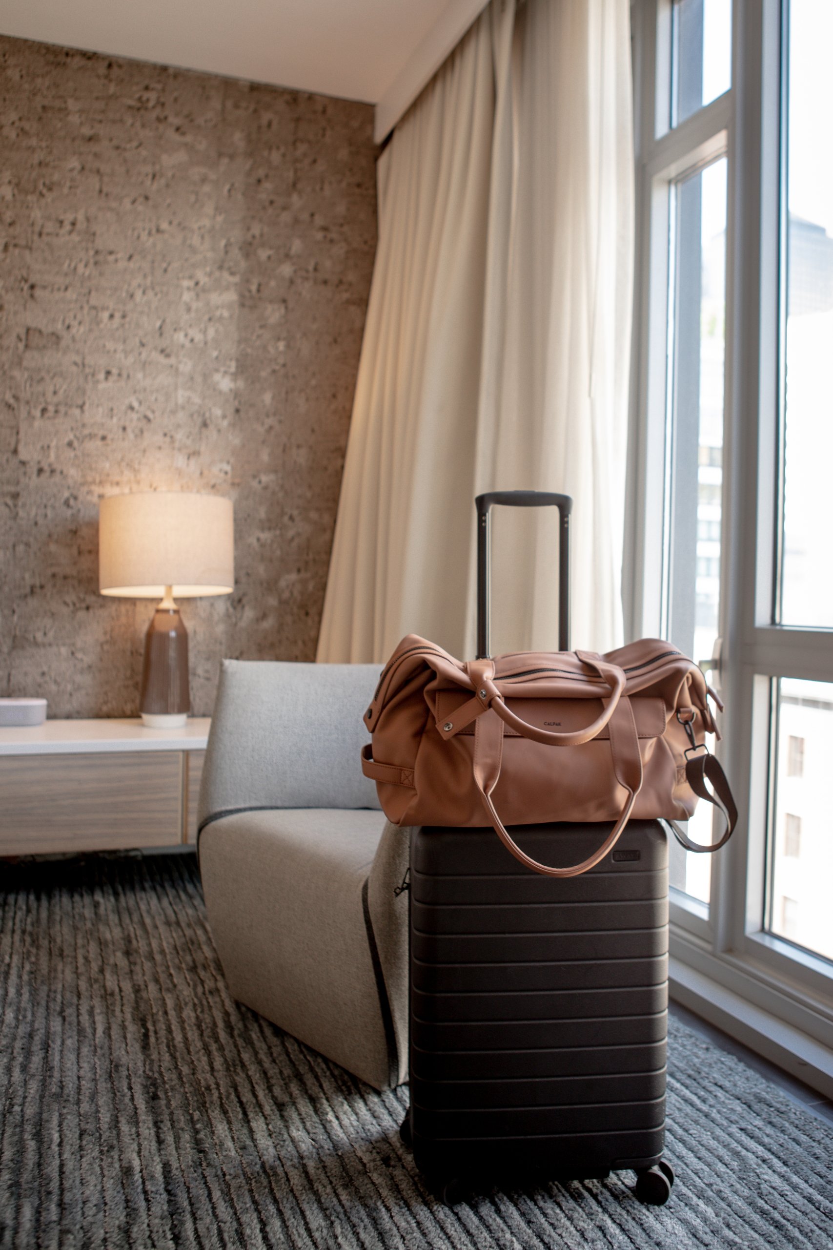 stylish leather bag in a luxurious hotel room at Smyth Tribeca NYC