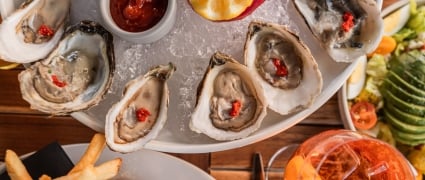 Oyster dish with dips and fries.