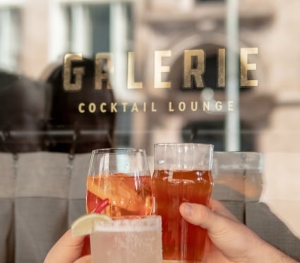 cheers with beverages at the bar