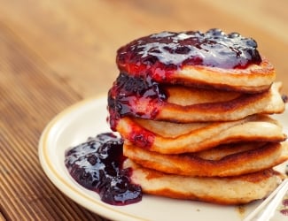 Homemade Breakfast, pancakeswith fruit jam, on wooden table. Pastry food. Dessert for kids.