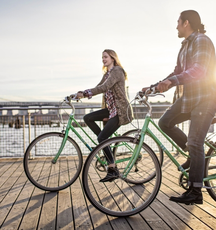 Couple enjoying cycling on promenade