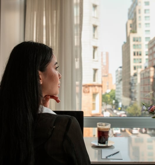 person at meeting table with coffee