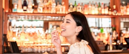 Woman enjoying cocktail at the Taverna New York; Smyth Tribeca hotel restaurant