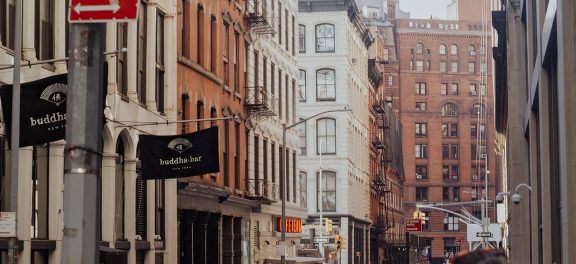 NYC people walking on the streets during the day;